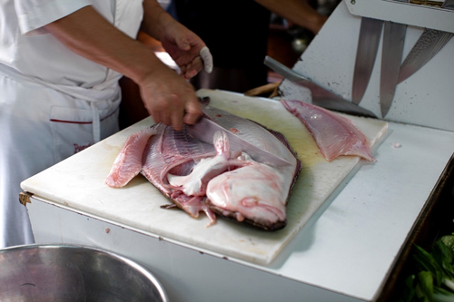 Javier Wong cuts an entire sole to be used in ceviche